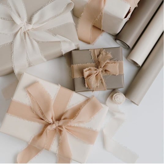 Gift boxes with ribbons and wrapping paper on a light background