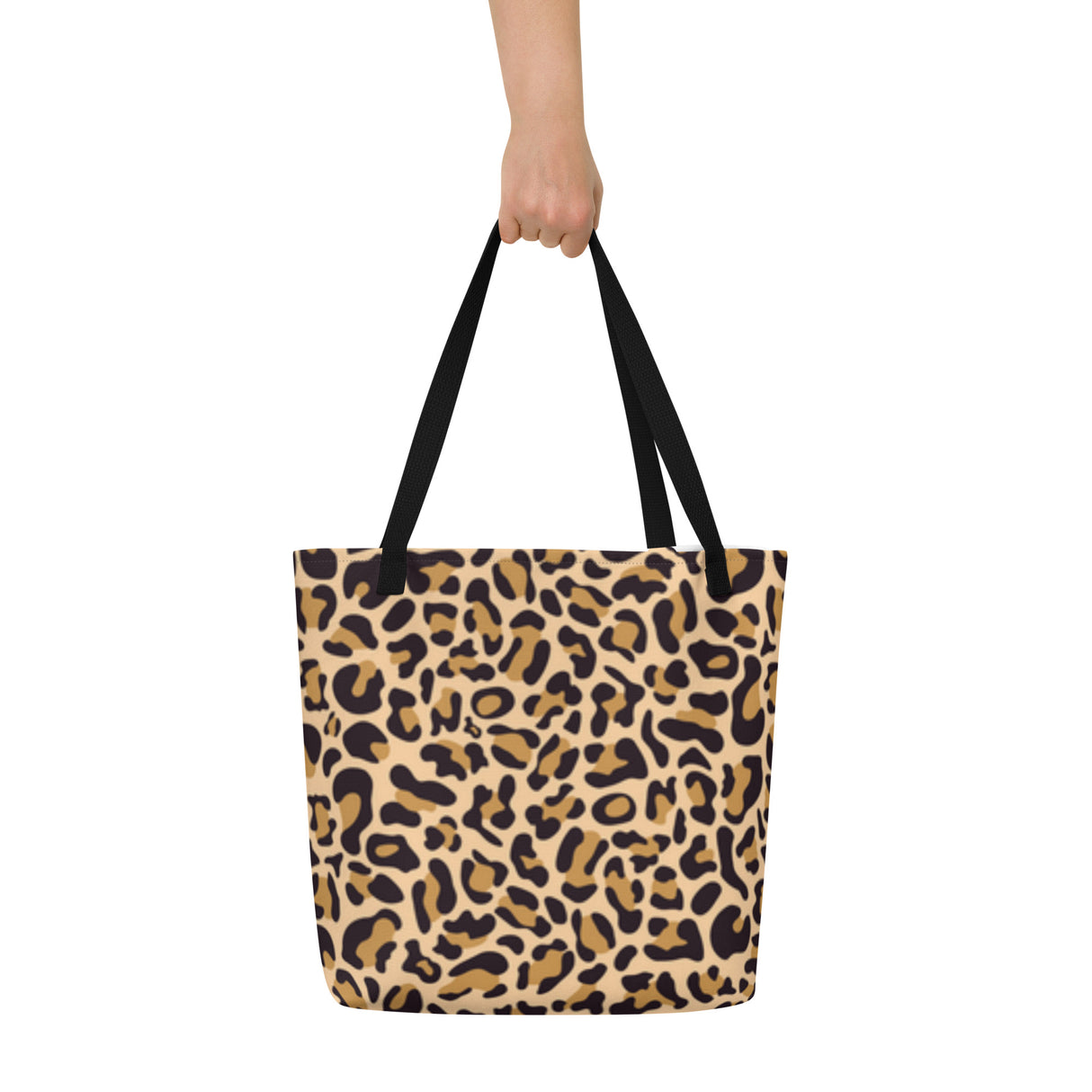 Leopard print tote bag held by a person on a white background