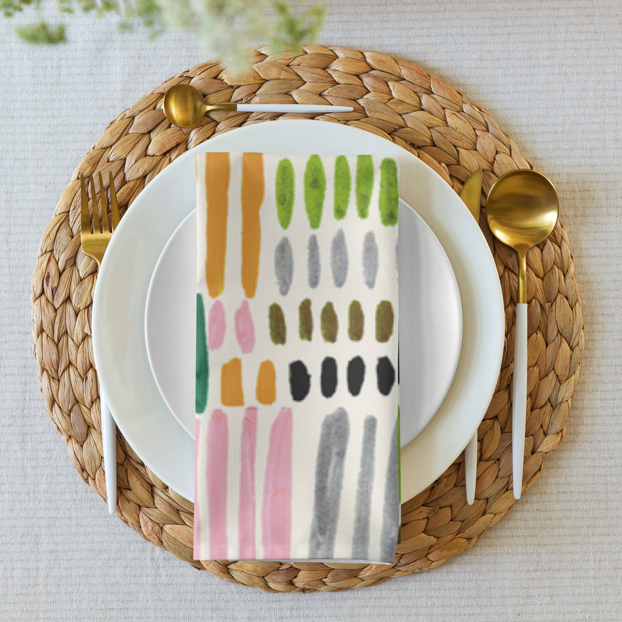 Plated setting with a colorful napkin on a woven placemat