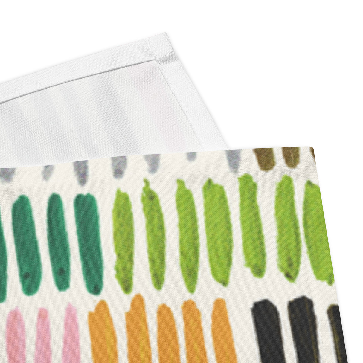 Colorful patterned paper with green, orange, and black strokes on a white background