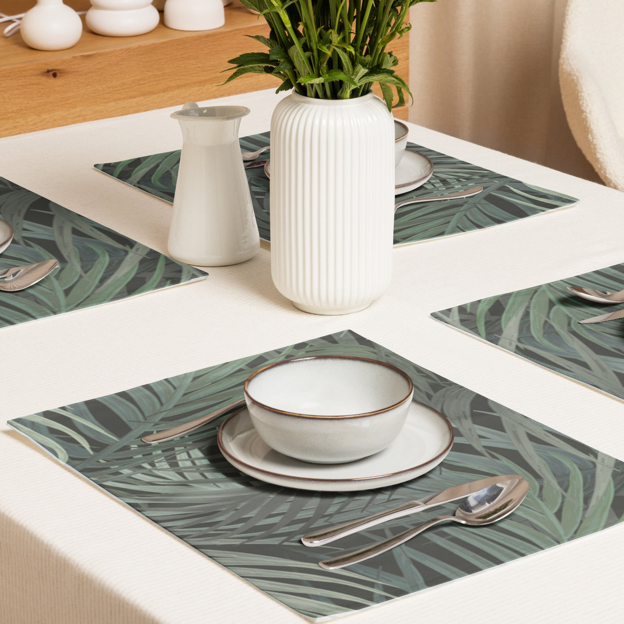 Leafy Luxe placemat set styled on dining table with white plates and silver cutlery