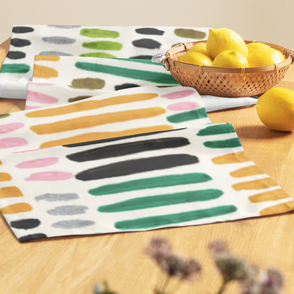 Colorful striped napkins on a wooden table with lemons.