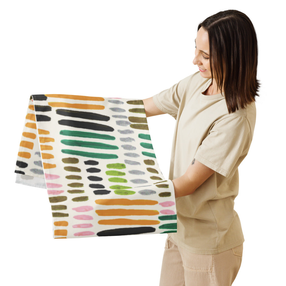 Woman holding a colorful patterned blanket against a white background