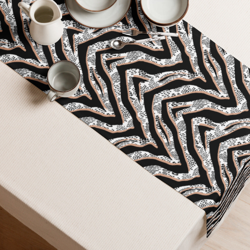 Savannah Stripes table runner with bold black and white abstract pattern styled on a dining table.