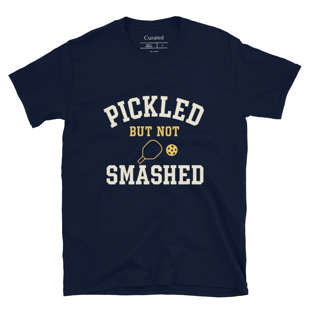 Navy blue t-shirt with 'Pickled But Not Smashed' text and pickleball graphics on a white background.