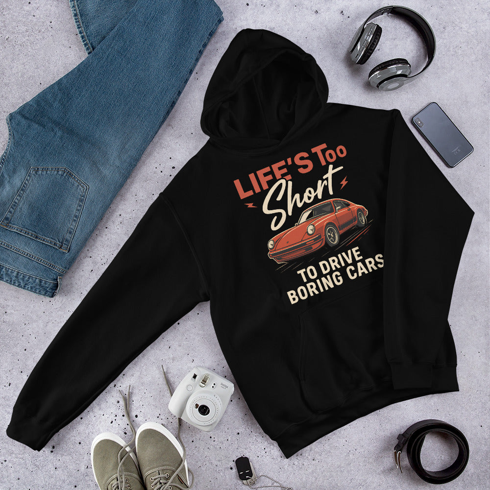 Black hoodie featuring a bold red Porsche 911 and “Life’s Too Short to Drive Boring Cars” text design.