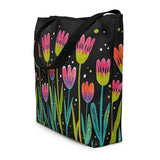 Black tote bag with colorful tulip pattern on a white background
