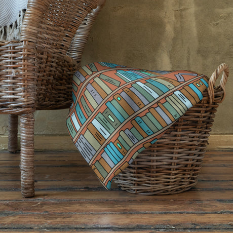 Cozy book-themed throw blanket with illustrated library shelves – perfect gift for book lovers.